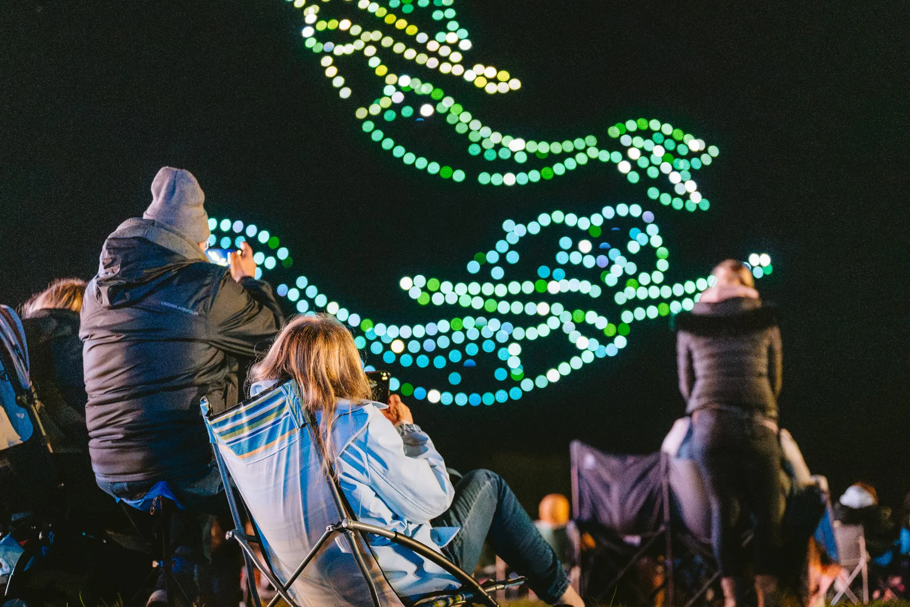 Audience enjoying a synchronized drone show